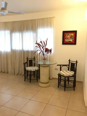 a dining room with a table and chairs and a window at Faro del Parque in Cordoba