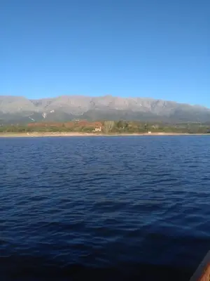 a large body of water with mountains in the background at Hotel San Huberto Tenis in Nono