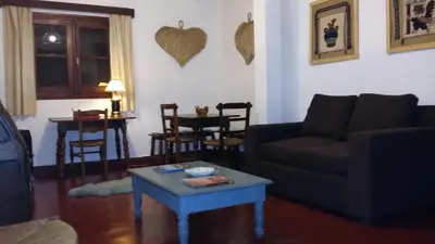 a living room with a couch and a table at Hotel San Huberto Tenis in Nono