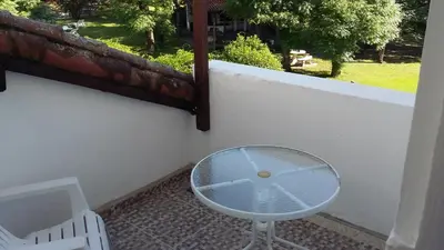 a glass table and a chair on a balcony at Hotel San Huberto Tenis in Nono