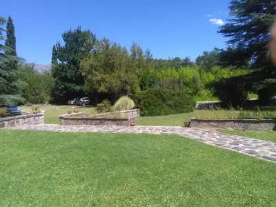 a garden with a stone path in the grass at Hotel San Huberto Tenis in Nono