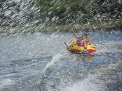 two people on a raft in the water at La Matilde in Villa Ciudad de America