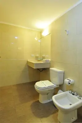a bathroom with a toilet and a sink at Los Sauces Hotel & Spa in Villa Carlos Paz
