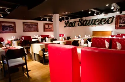 a dining room with tables and chairs in a restaurant at Los Sauces Hotel & Spa in Villa Carlos Paz