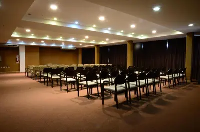 a large room with a long table and chairs at Los Sauces Hotel & Spa in Villa Carlos Paz
