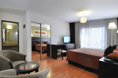 a hotel room with a bed and a desk at Los Sauces Hotel & Spa in Villa Carlos Paz