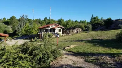a house in the middle of a field at Aires Serranos - Suites in La Cumbrecita