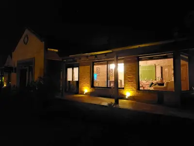 a house at night with lights in the windows at Refugio Del Guira Guira in Los Reartes