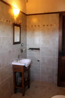 a bathroom with a sink and a shower at Refugio Del Guira Guira in Los Reartes