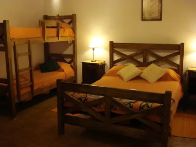 a bedroom with two bunk beds and a ladder at Las Acacias - Posada de Campo in Villa General Belgrano