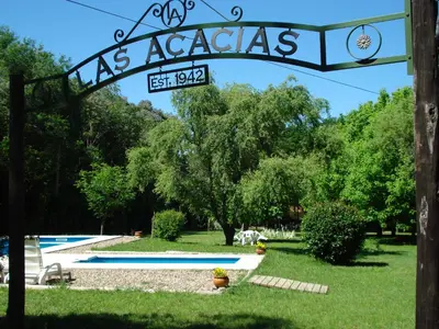 a sign that reads as acadias next to a pool at Las Acacias - Posada de Campo in Villa General Belgrano