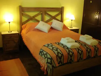 a bedroom with a bed with towels on it at Las Acacias - Posada de Campo in Villa General Belgrano