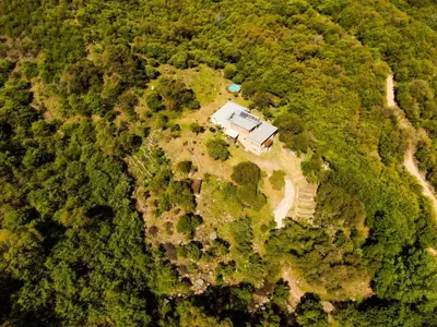 an aerial view of a house in the middle of a forest at Tierra Sagrada Eco Lodge in La Población