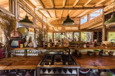 a kitchen with a stove top oven in a room at Tierra Sagrada Eco Lodge in La Población
