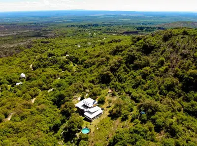 an aerial view of a house in the middle of a forest at Tierra Sagrada Eco Lodge in La Población