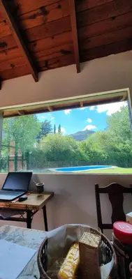 a window in a room with a laptop on a table at Cabaña Odanak in Villa General Belgrano