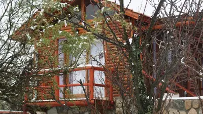 a log house with a window on the side of it at Cabañas Yanasuy in Merlo