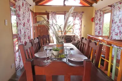 a dining room with a table and chairs at Cabañas Yanasuy in Merlo