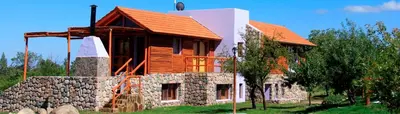 a house being built with a stone wall at Cabañas Yanasuy in Merlo