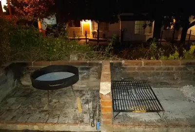 a grill sitting on the side of a street at Complejo Viejo Sulky in Mina Clavero