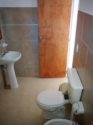 a bathroom with a toilet and a sink at El Camino Hostel in Mina Clavero