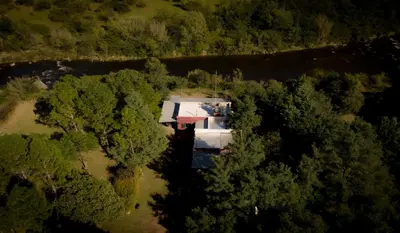 an aerial view of a house surrounded by trees at Cabañas Nueve Lunas in Santa Rosa de Calamuchita
