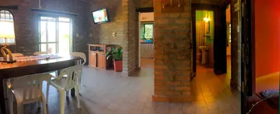 a kitchen and dining room with a table and chairs at Cabañas Nueve Lunas in Santa Rosa de Calamuchita