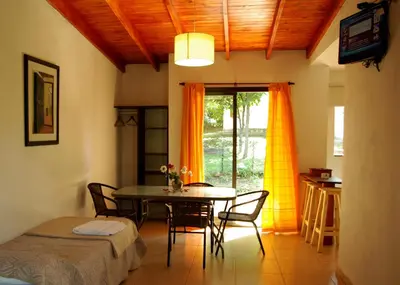 a dining room with a table and chairs and a window at Amaikén Suites in Nono