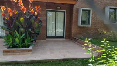 a front door of a brick house with flowers at Amaikén Suites in Nono