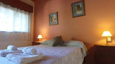 a bedroom with a bed with towels on it at Hosteria Nilo Azul in Mina Clavero