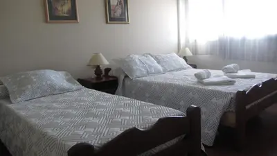 a bedroom with two beds with towels on them at Hosteria Nilo Azul in Mina Clavero