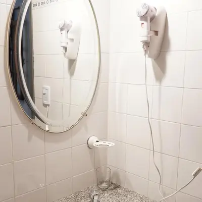 a bathroom with a mirror and a sink at Hostel & Spa Mediterránea in Cordoba