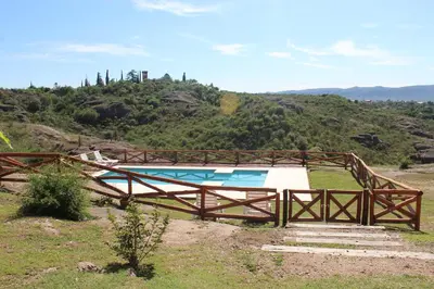a swimming pool on top of a hill at Cabañas del Rey in Villa Carlos Paz