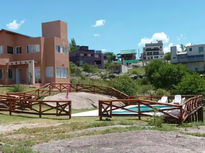 a group of wooden frames in front of a building at Cabañas del Rey in Villa Carlos Paz