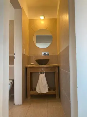 a bathroom with a sink and a mirror at Cabañas del Rey in Villa Carlos Paz