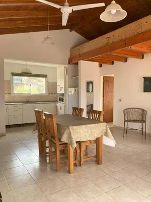 a kitchen and dining room with a table and chairs at Cabañas del Rey in Villa Carlos Paz