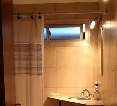 a bathroom with a sink and a shower curtain at Nueva Córdoba Rondeau in Cordoba