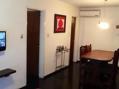 a dining room with a wooden table and a table and chairs at Nueva Córdoba Rondeau in Cordoba