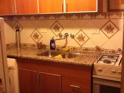 a kitchen counter with a sink and a stove at Nueva Córdoba Rondeau in Cordoba