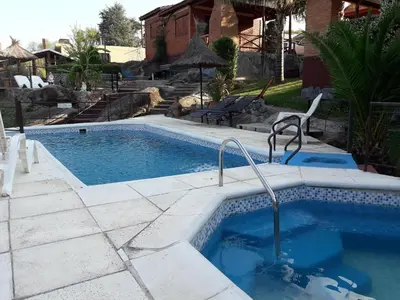 a swimming pool in the middle of a yard at Cabañas Layken in Villa Carlos Paz