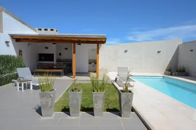 a patio with a swimming pool and a pergola at Corzuelas Aparts - Mina Clavero in Mina Clavero
