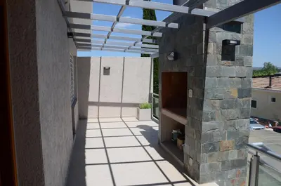 a patio with awning on the side of a building at Corzuelas Aparts - Mina Clavero in Mina Clavero