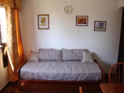 a bedroom with a bed in a room at Departamento Maipu Cordoba in Cordoba