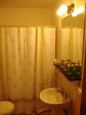 a bathroom with a shower curtain and a sink at Departamento Maipu Cordoba in Cordoba