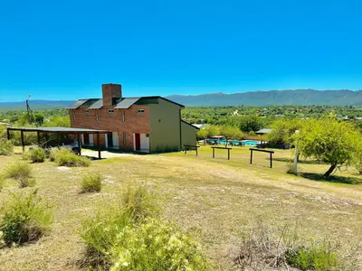 an old brick building in the middle of a field at Complejo Acanto in Villa Carlos Paz