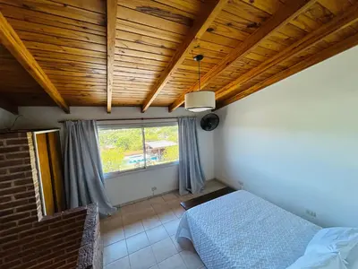 a bedroom with a bed and a window at Complejo Acanto in Villa Carlos Paz