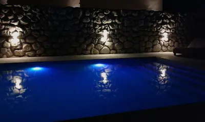 a swimming pool with blue lights in a room at Parque Los Nogales Apart Hotel in Merlo