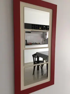 a mirror with a table in a room at Apartamento 5 Carcano in Villa Carlos Paz