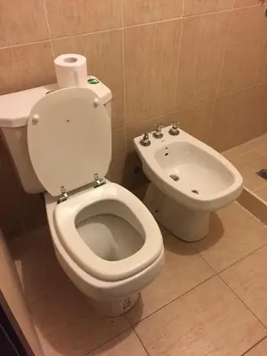 a bathroom with a toilet and a bidet at Apartamento 5 Carcano in Villa Carlos Paz