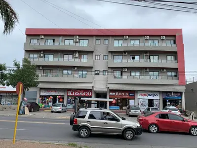 two cars parked in front of a building at Apartamento 5 Carcano in Villa Carlos Paz